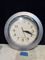 Front view of quartz wall clock showing face and frame