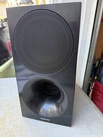 Front view showing grille and bass port of Samsung subwoofer