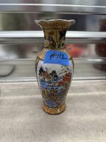 Front view of vase with village and river scene
