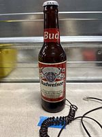 Front view of Budweiser bottle telephone showing label and cord