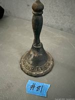 Full view of cast iron hand bell showing inscription