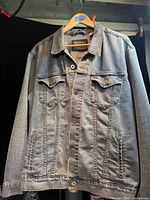 Front view of Levi’s Signature denim jacket hanging on hanger