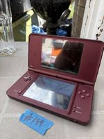 Open Nintendo DSi XL showing screens and controls