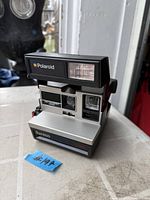 Front view of Polaroid Sun 600 LMS camera showing lens, flash and branding