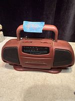 Front angled view showing carry handle, speaker grilles and tuning window