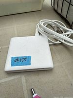 Top view of white adapter with attached cable