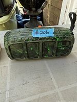 Front view of green camo Avalanche Bluetooth speaker showing grille and carry loop
