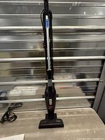 Full view of Bissell MagicVac stick vacuum standing upright