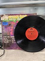 Front cover with vinyl record showing red Polydor label and worn sleeve