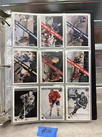 Binder open to first nine-card page of hockey cards