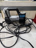 Full view of Husky inflator with cords and gauge