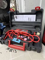Open case showing rotary tool, accessories, manual