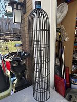 Tall cylindrical black iron candle holder standing upright, approx 38.5 in height