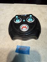 Top view of Nintendo Mario Kart remote controller showing joysticks, logo, controls