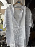 Front view of the short-sleeve striped cotton shirt hanging