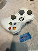 Front view showing buttons and sticks of white Xbox 360 wireless controller