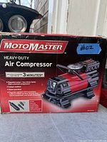 Front of sealed box showing MotoMaster heavy-duty air compressor