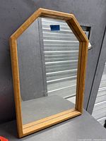 front view of oak framed wall mirror showing frame shape and mirrored surface