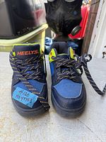 Top view of both sneakers showing uppers, laces, tongue branding