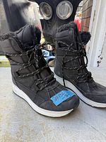 Full view of both boots side profile showing uppers, laces, faux-fur trim and midsoles