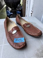 Overall view of pair of brown leather loafers