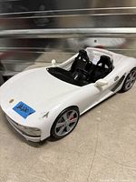 Front left angled view showing overall car shape, color, wheel and body condition