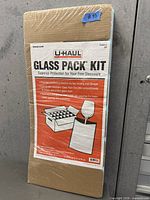 Front view of sealed U-Haul Glass Pack Kit package