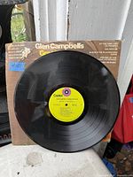 Front of Glen Campbell’s Greatest Hits LP with vinyl and worn sleeve visible