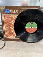 Front of worn Aquarelle sleeve with record displayed