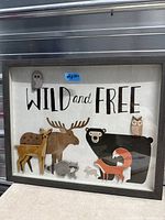 Front view of framed "Wild and Free" wall art with woodland animal cutouts
