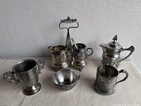 Group shot of all silver plated pieces in lot