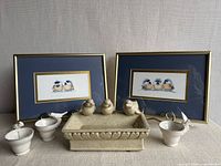 Group shot of both prints, ceramic dish, and four cups