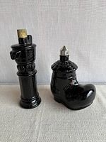 Both black glass Avon decanters upright