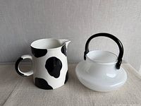 Pitcher and handled dish side-by-side