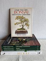 Stack of all five hardcover gardening books showing titles and spines