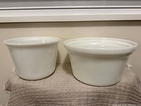 Two white milk glass bowls side by side