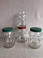 Group shot of both glass bear jars showing relative sizes and lids