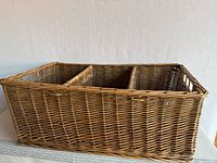 Side view of rectangular wicker basket showing woven design and side handle