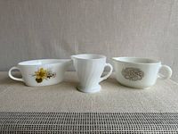 Front view of three milk glass pieces