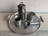 Lot overview showing Milcraft tray, milk can, measuring cup, creamer, and juicer