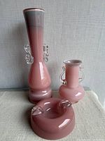 Group shot of three pink art glass pieces