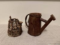 Two watering-can shaped planters side by side