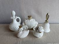 front view of all five Avon milk glass bottles