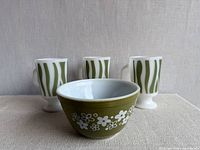 Front view of Pyrex bowl and three Fire-King mugs