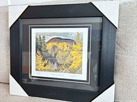 Framed print with corner protectors visible