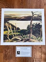 Full view of unframed “Frood Lake” print with information card beneath