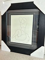 Framed lithograph with corner protectors on frame