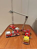 Three Majorette fire vehicles displayed with ladder extended