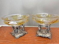Full view of the two glass compotes on silverplate bases