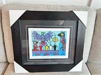 Framed print on sofa showing full frame with corner protectors